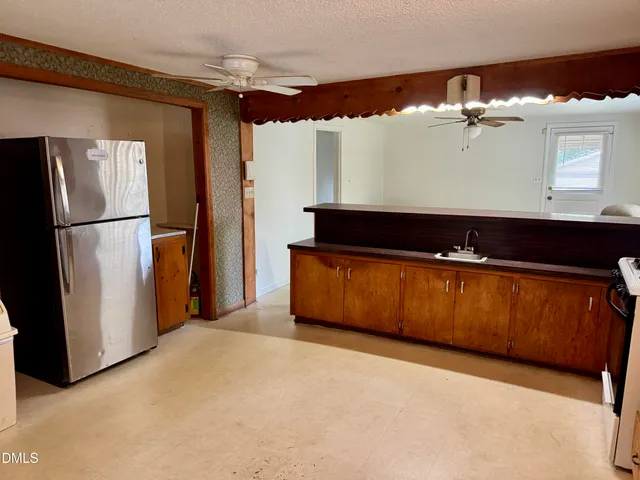a kitchen with stainless steel appliances granite countertop a refrigerator and a sink