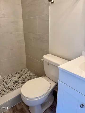 a white toilet sitting next to a bathroom sink