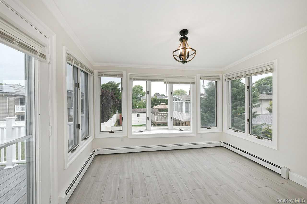 107 Beverly Road Massapequa, NY 11758 - Photo 14 of 41 a view of an entryway with wooden floor