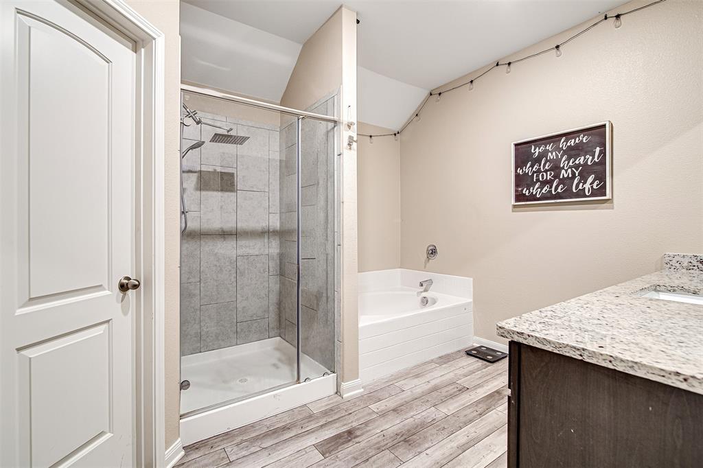 1813 Rialto Lane Crowley, TX 76036 - Photo 17 of 27 a bathroom with a tub a sink and a shower