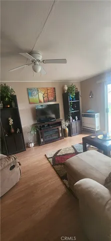 a living room with furniture gym equipment and a flat screen tv