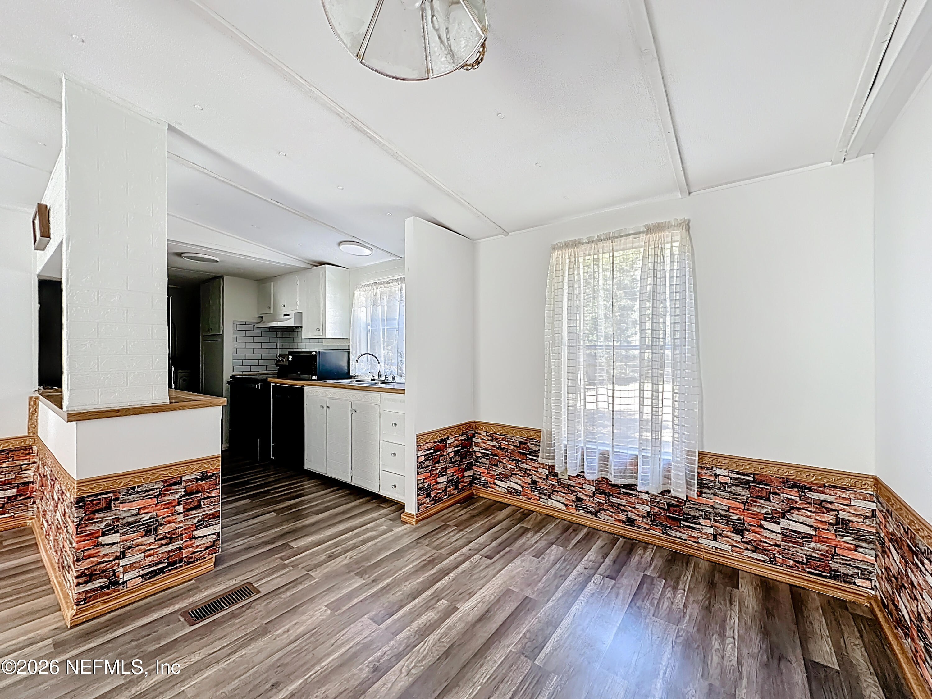 133 Reaves Avenue Interlachen, FL 32148 - Photo 12 of 38 a living room with furniture and a wooden floor