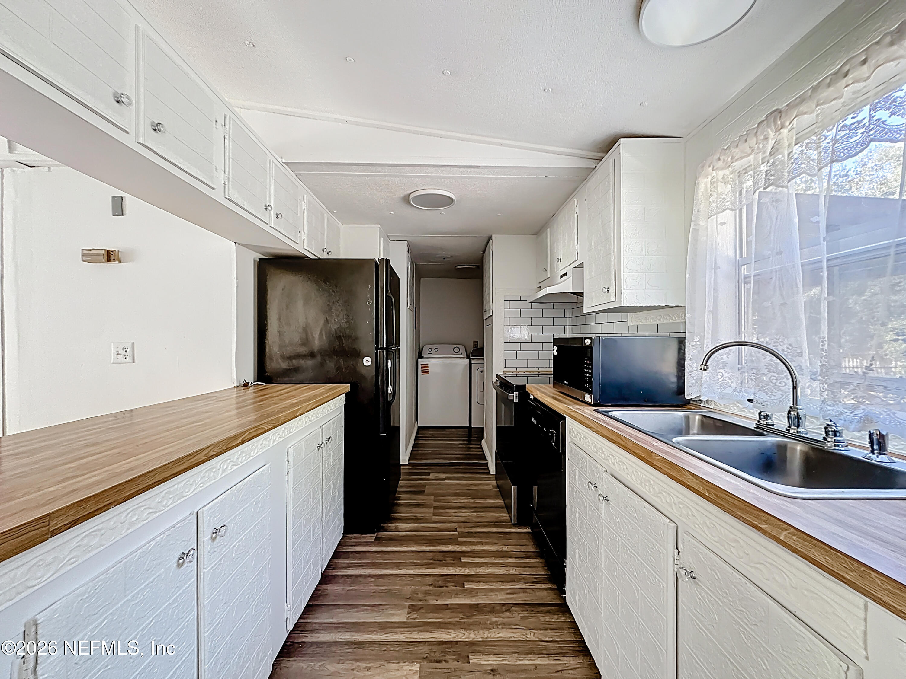 133 Reaves Avenue Interlachen, FL 32148 - Photo 14 of 38 a large kitchen with stainless steel appliances granite countertop a sink and cabinets