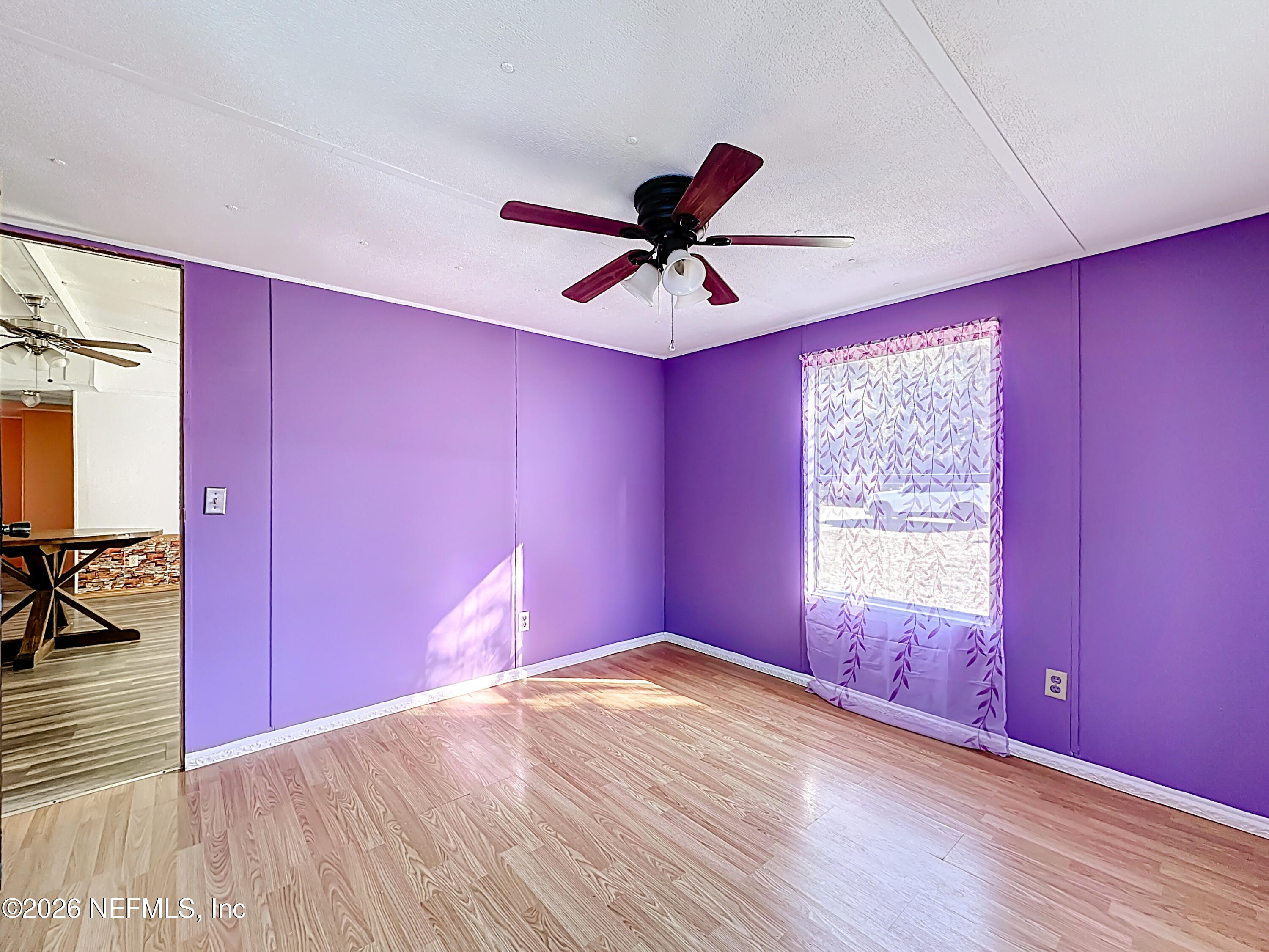 133 Reaves Avenue Interlachen, FL 32148 - Photo 21 of 38 a view of empty room with wooden floor and fan