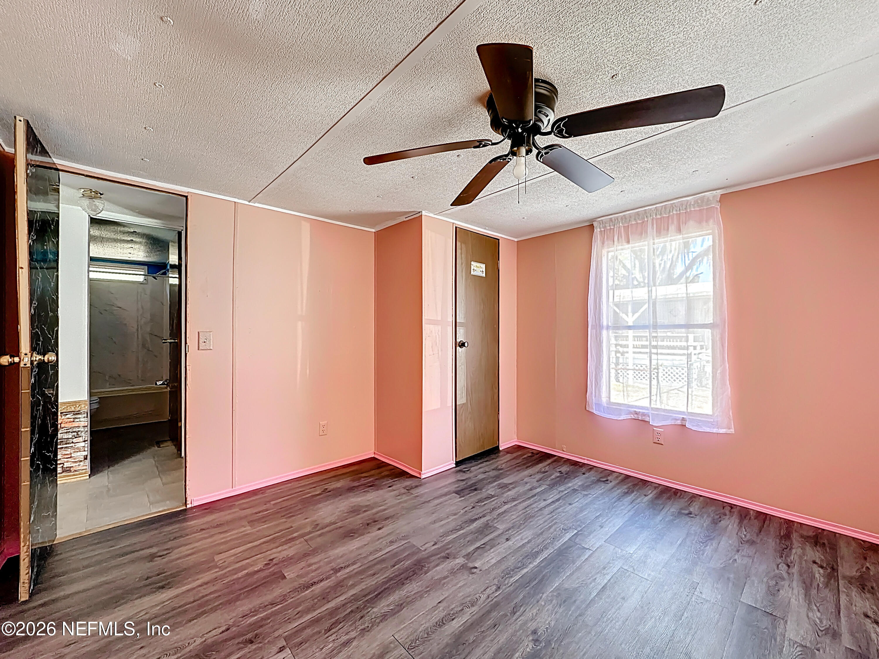 133 Reaves Avenue Interlachen, FL 32148 - Photo 28 of 38 a view of empty room with wooden floor and fan
