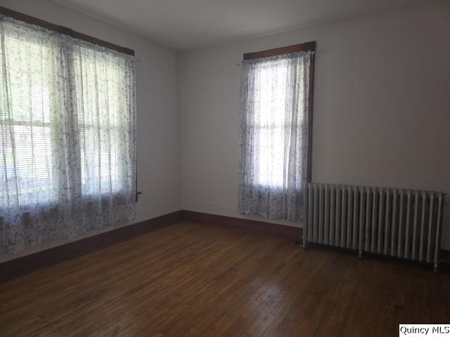 210 Main Street Carthage, IL 62321 - Photo 15 of 36 a view of an empty room with wooden floor and a window