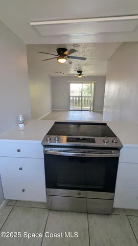 an empty room with wooden floor and mirror
