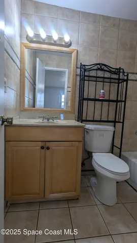 an empty room with wooden floor ceiling fan and window