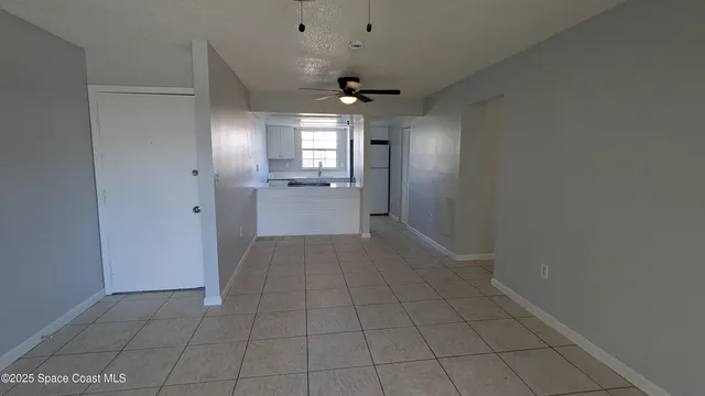 a kitchen with a sink a refrigerator and window