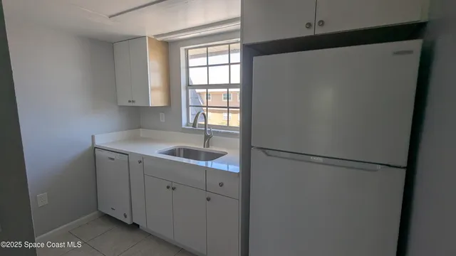 a stove top oven sitting inside of a kitchen