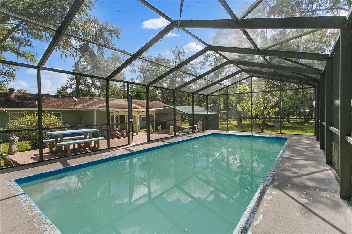 3351 Pacetti Road St. Augustine, FL 32092 - Photo 17 of 24 a view of a swimming pool with a patio and a yard