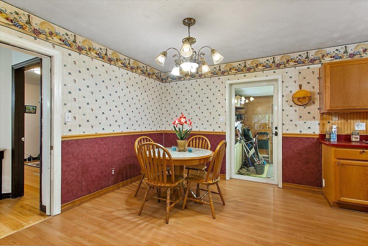 3351 Pacetti Road St. Augustine, FL 32092 - Photo 9 of 24 a dining room with furniture a chandelier and wooden floor