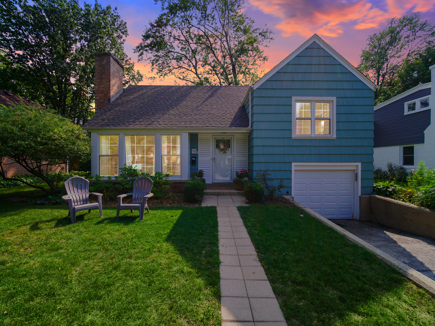 a front view of a house with garden and porch