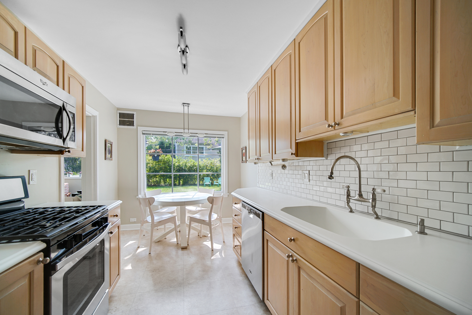 92 Williamsburg Road Evanston, IL 60203 - Photo 9 of 14 a kitchen with a sink stove and cabinets
