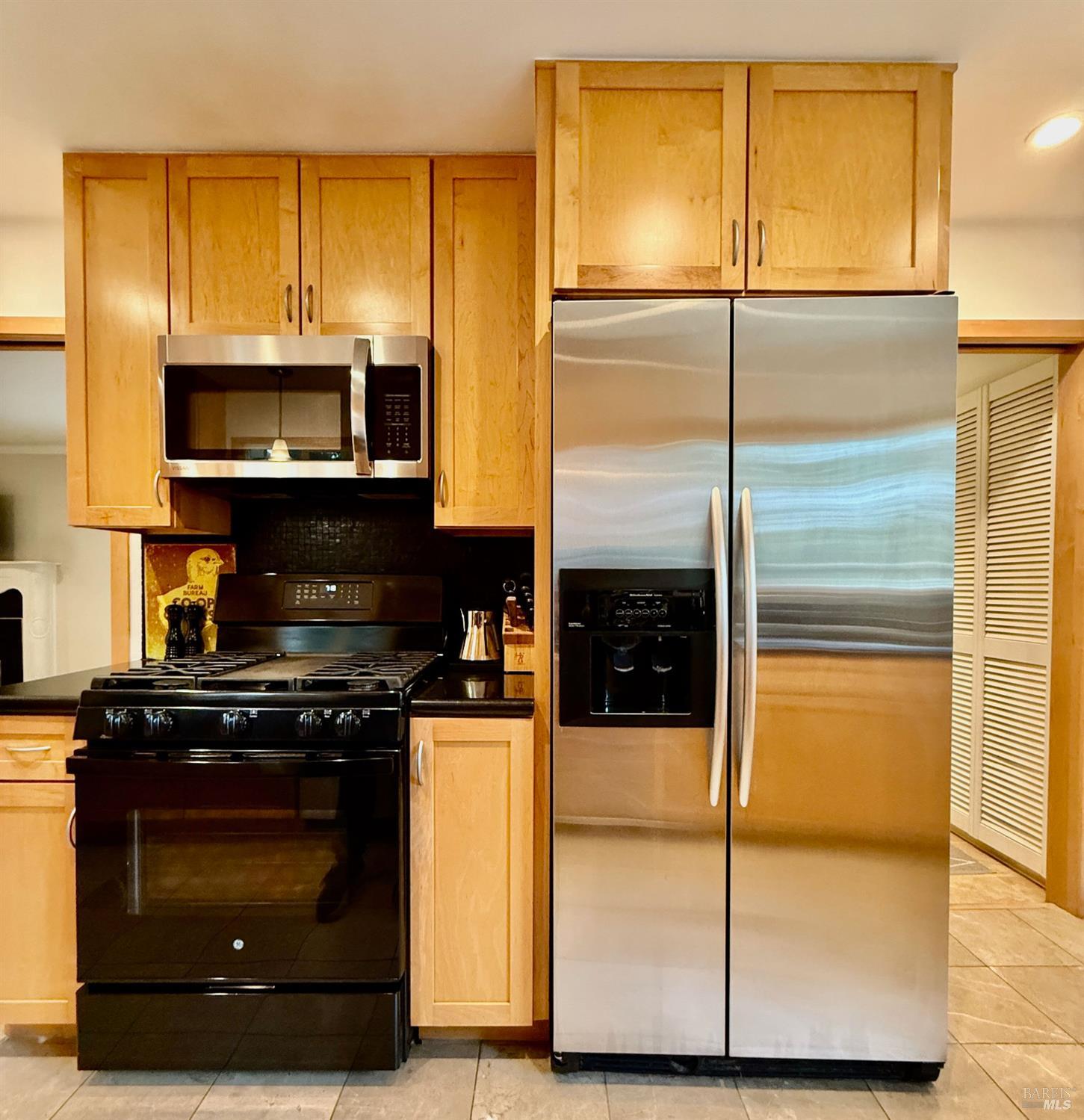 1607 Foothill Boulevard Calistoga, CA 94515 - Photo 13 of 27 a kitchen with granite countertop cabinets and steel stainless steel appliances with wooden floor