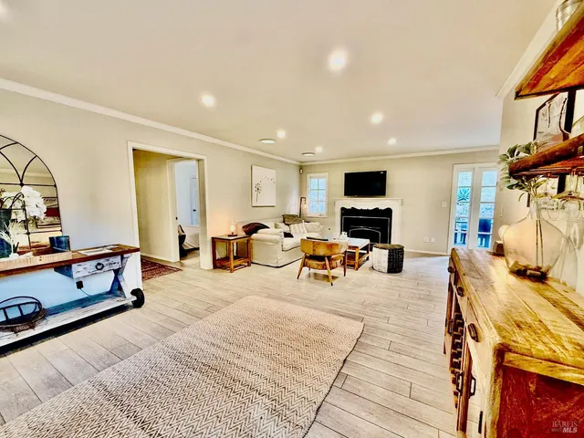 a view of a livingroom with furniture and a flat screen tv