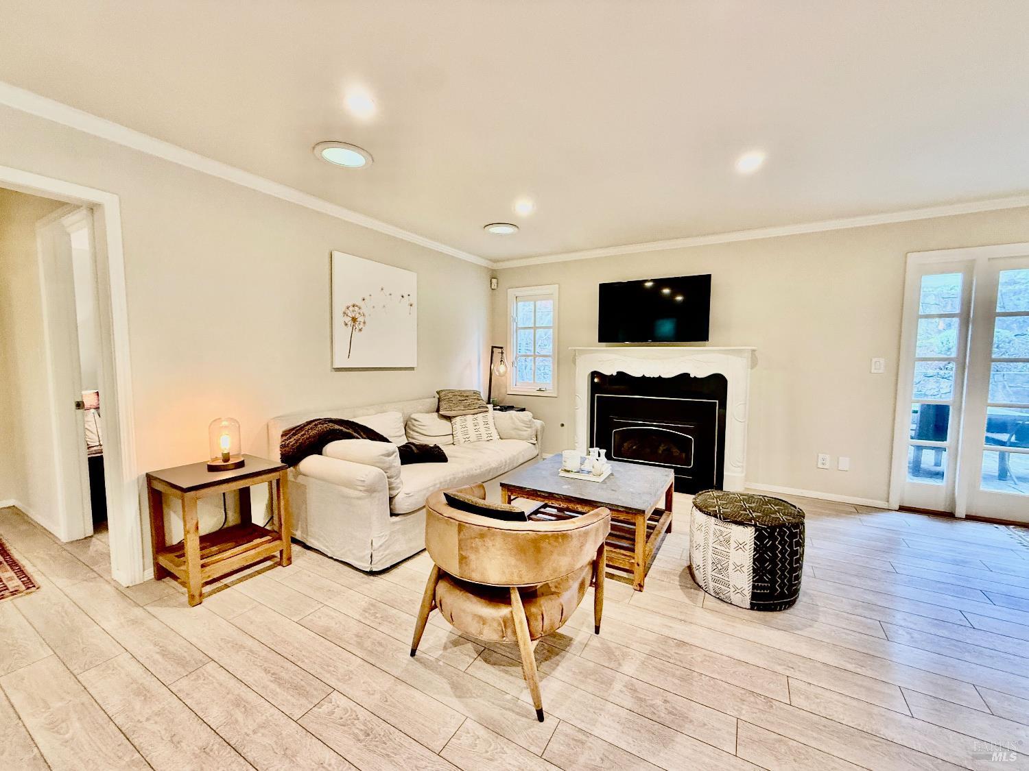 1607 Foothill Boulevard Calistoga, CA 94515 - Photo 4 of 27 a living room with furniture a flat screen tv and a fireplace