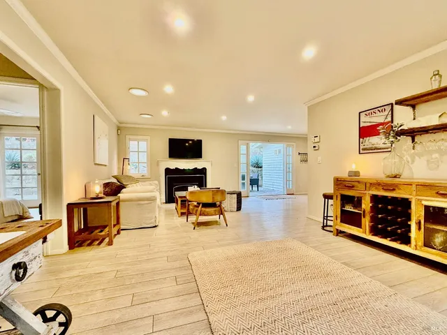 a living room with furniture a flat screen tv and a table