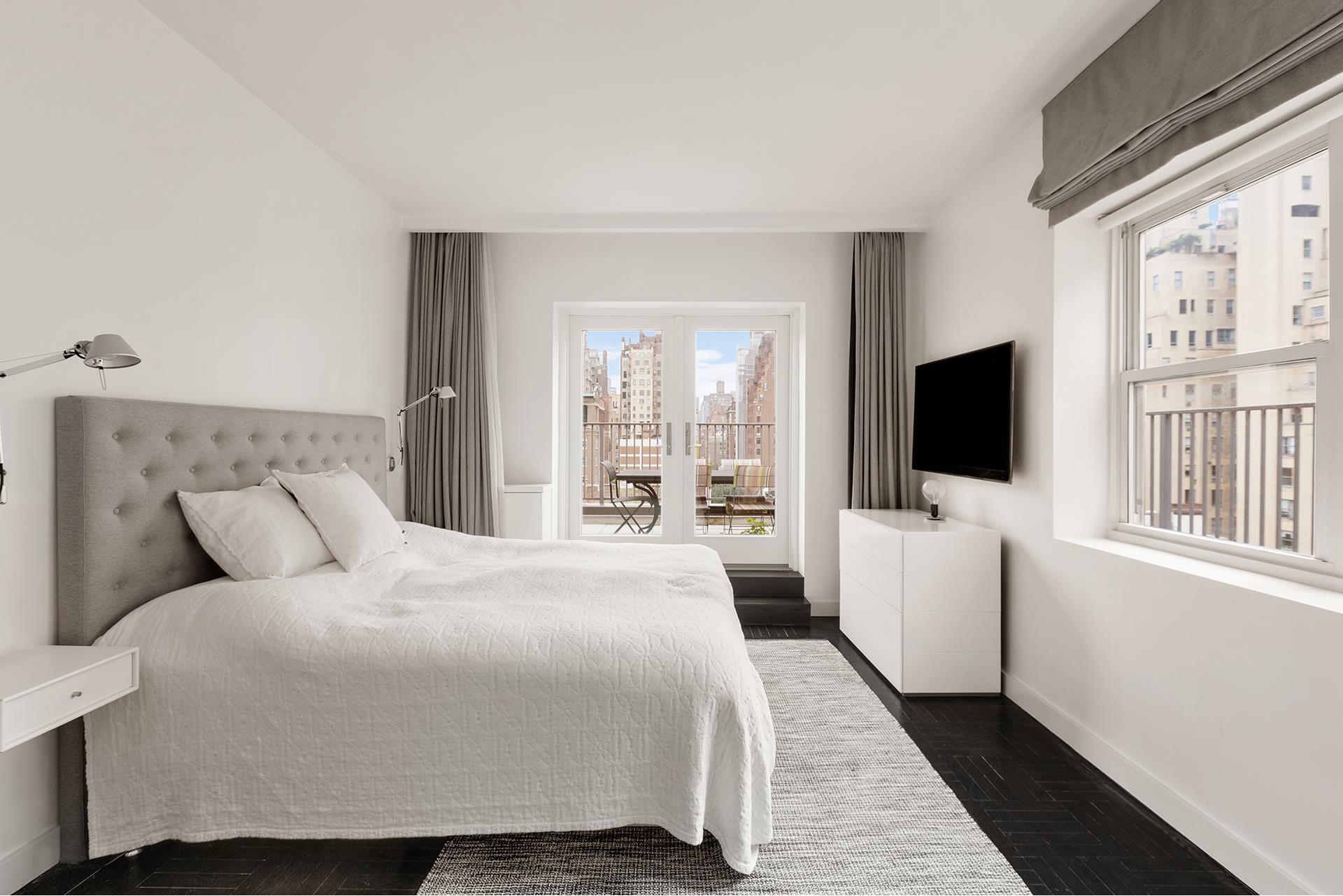 923 5th Avenue, Unit 12E/11 Manhattan, NY 10021 - Photo 11 of 14 a bedroom with a bed and a flat screen tv