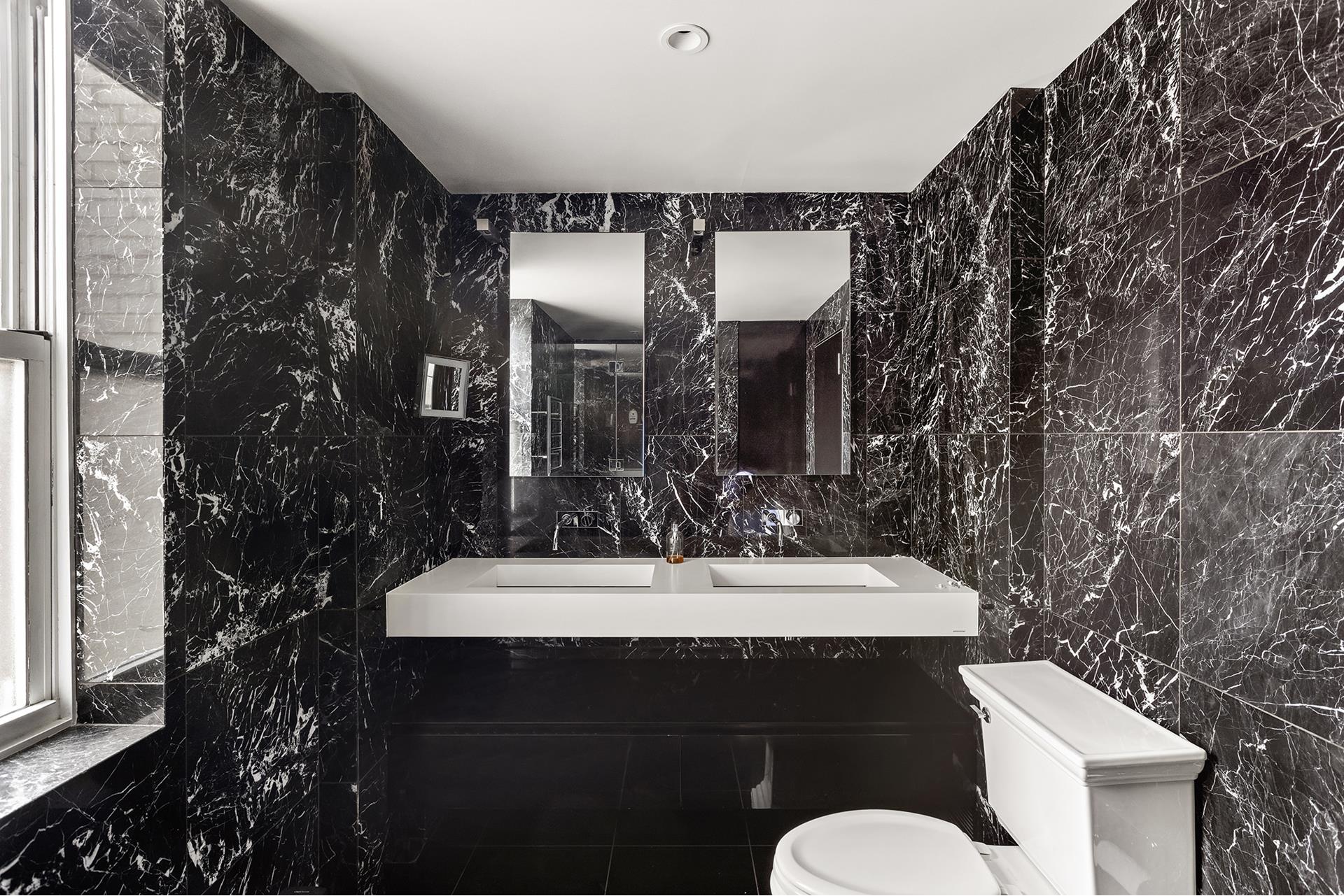 923 5th Avenue, Unit 12E/11 Manhattan, NY 10021 - Photo 8 of 14 a bathroom with a sink and mirror