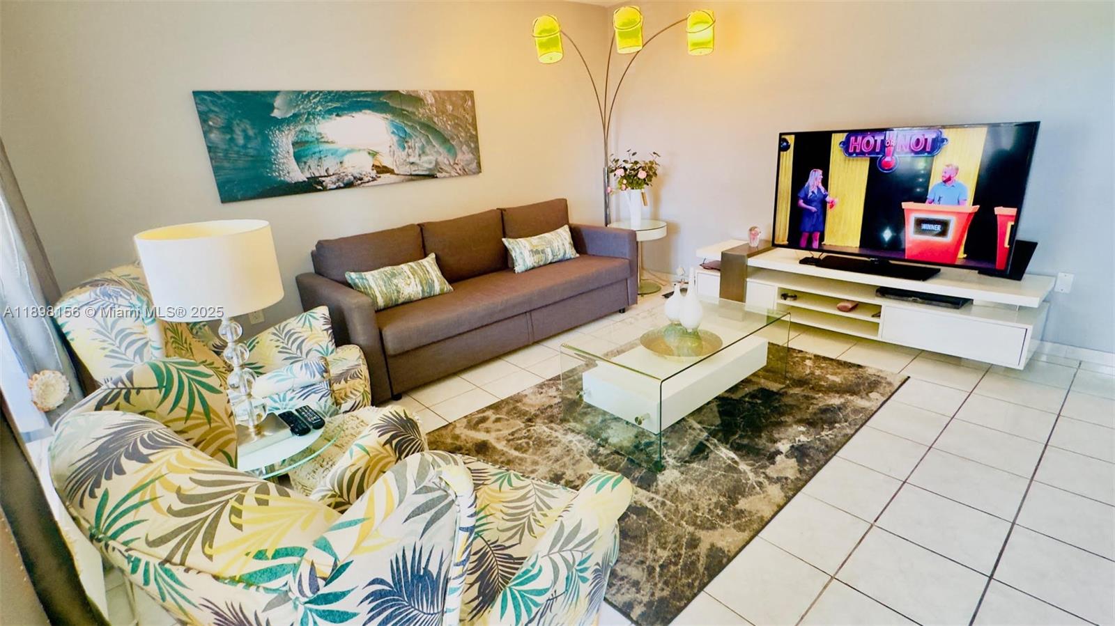 a living room with couch and painting on the wall