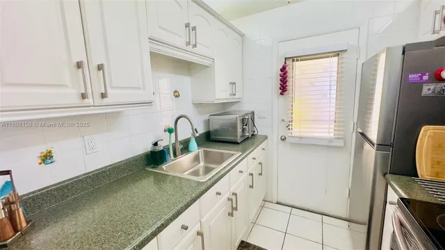 a kitchen with a sink cabinets and window