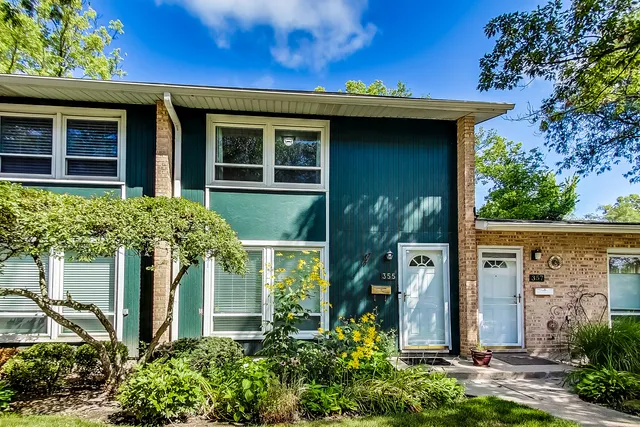 front view of a house with potted plants