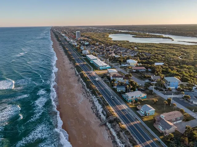 an aerial view of residential building and ocean