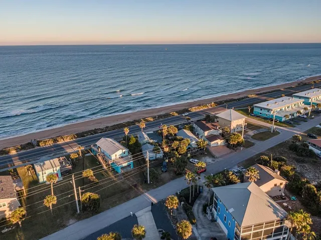 an aerial view of a city with ocean view