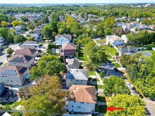 an aerial view of residential houses with outdoor space