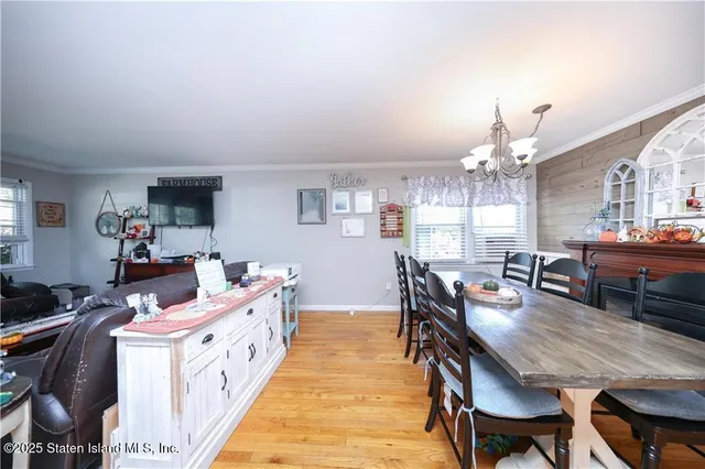a dining room with furniture and chandelier