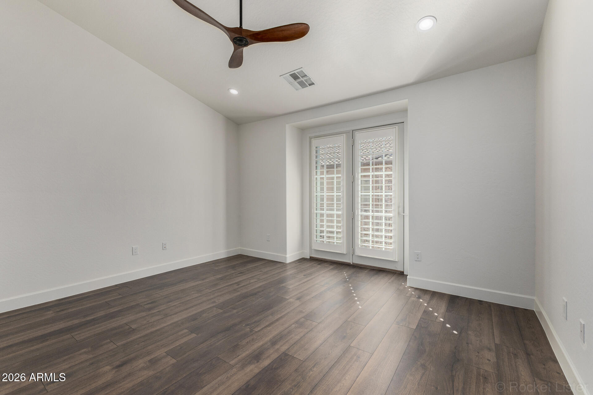 4424 North 24th Way Phoenix, AZ 85016 - Photo 12 of 39 a view of an empty room with wooden floor and a window