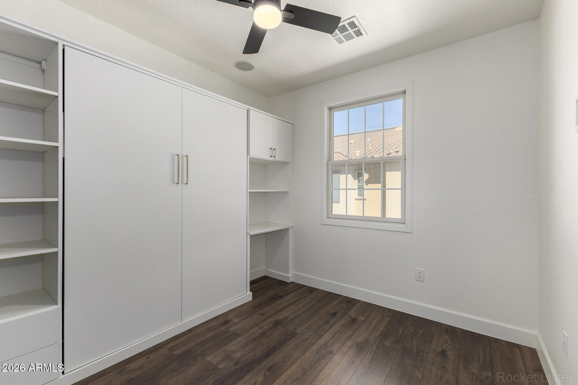 4424 North 24th Way Phoenix, AZ 85016 - Photo 19 of 39 a view of an empty room with wooden floor and a window