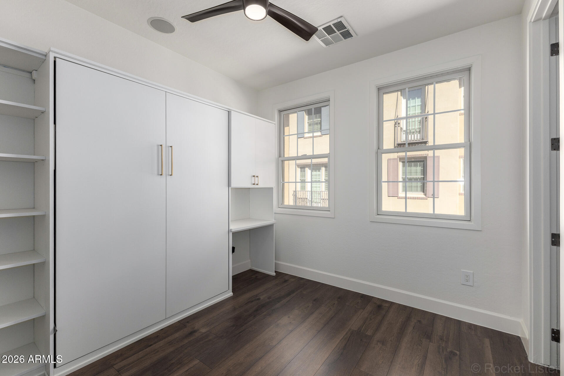 4424 North 24th Way Phoenix, AZ 85016 - Photo 22 of 39 an empty room with wooden floor and windows