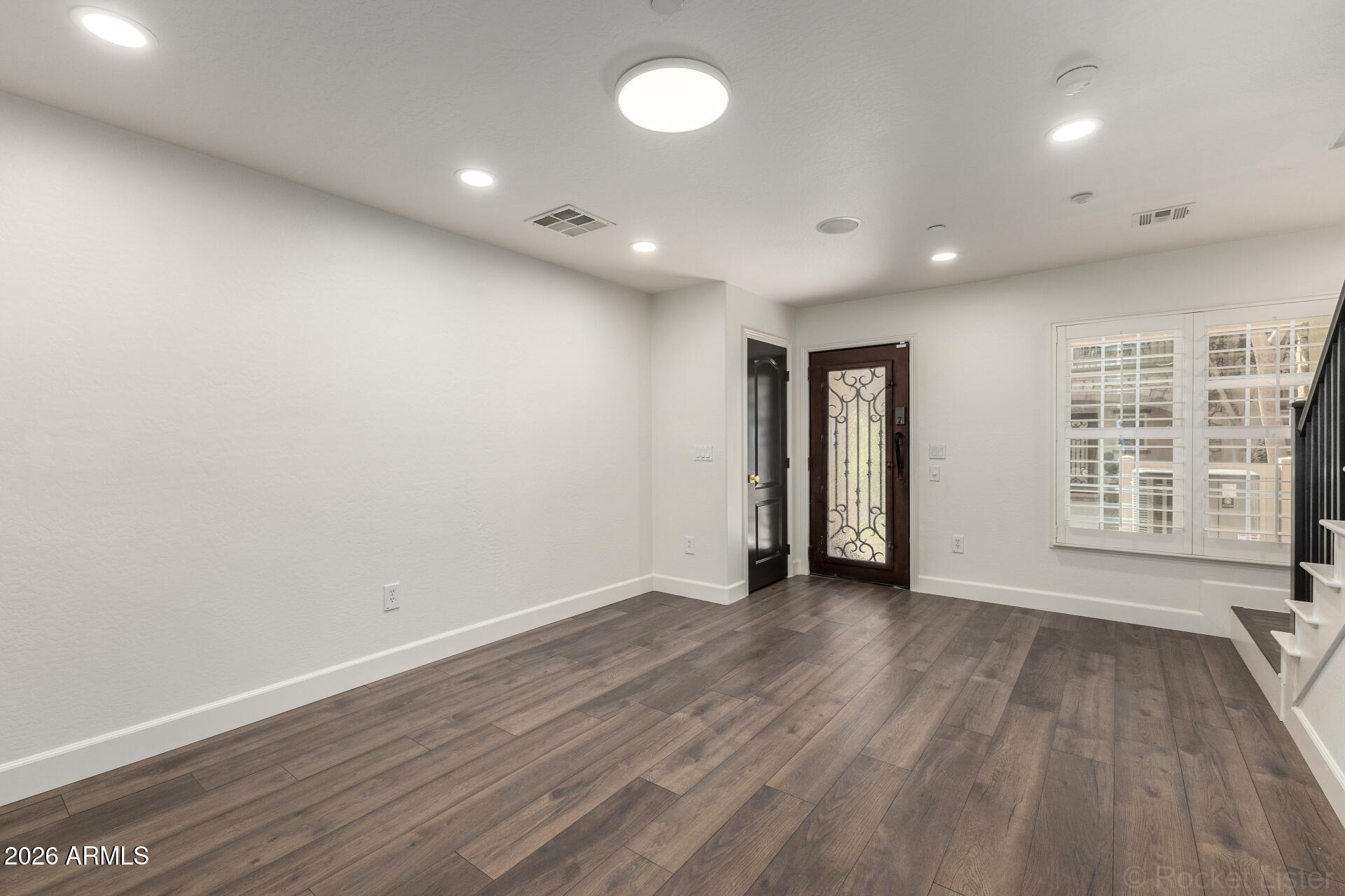 4424 North 24th Way Phoenix, AZ 85016 - Photo 27 of 39 an empty room with wooden floor and windows