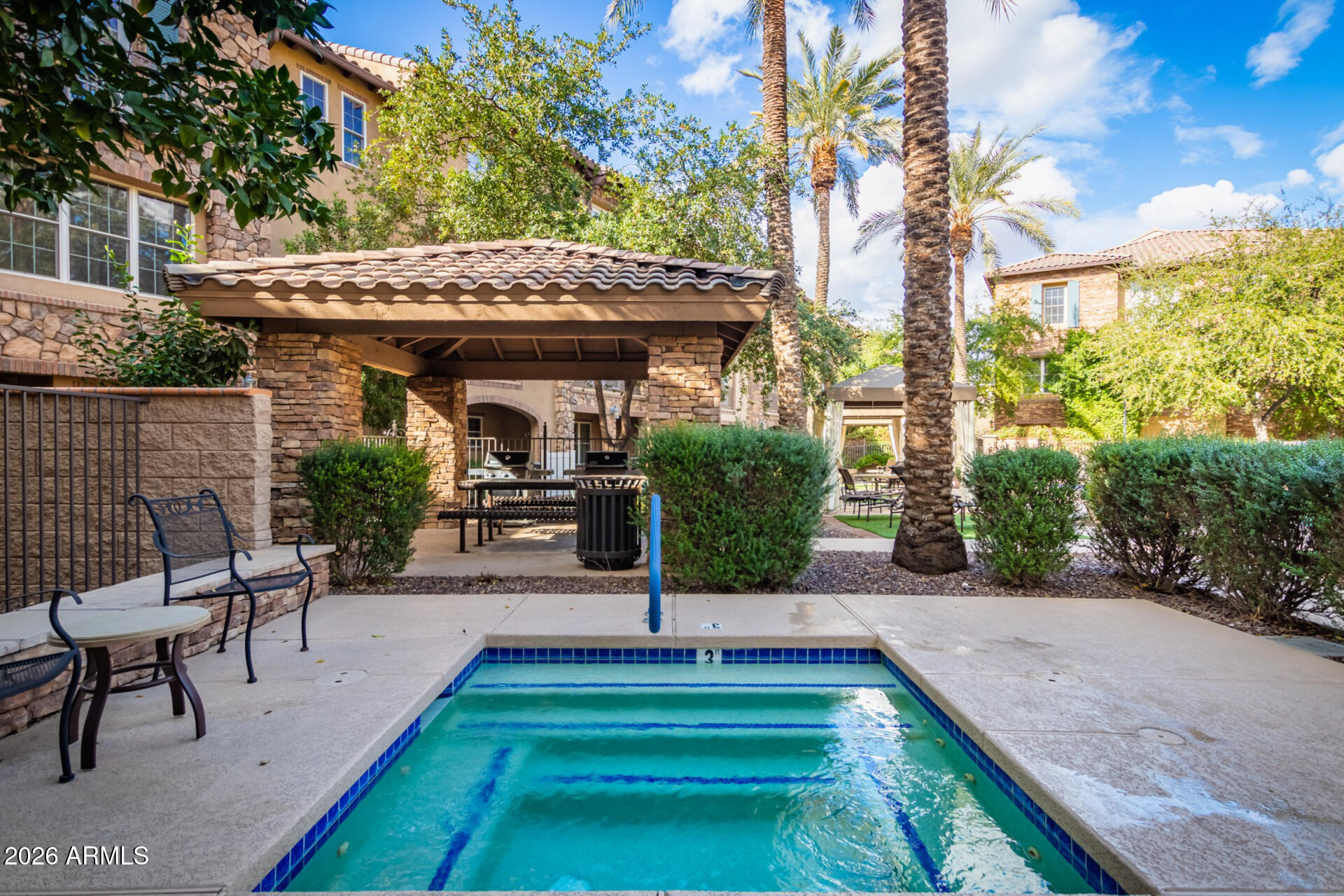 4424 North 24th Way Phoenix, AZ 85016 - Photo 36 of 39 a view of a patio with table and chairs potted plants and a palm tree