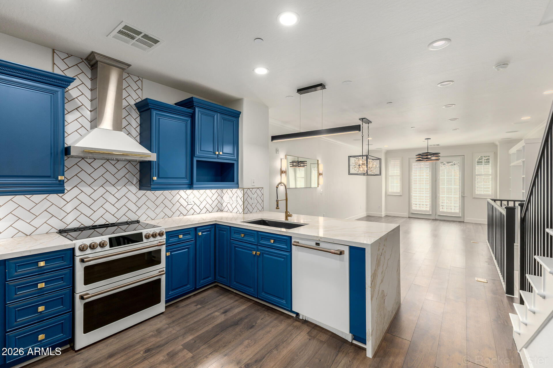 4424 North 24th Way Phoenix, AZ 85016 - Photo 9 of 39 a kitchen with stainless steel appliances granite countertop wooden floors and sink