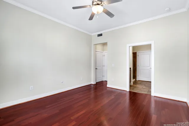 a view of an empty room with wooden floor