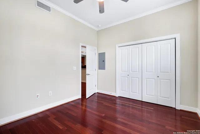 a view of an empty room with wooden floor