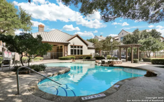 a view of a house with swimming pool and sitting area