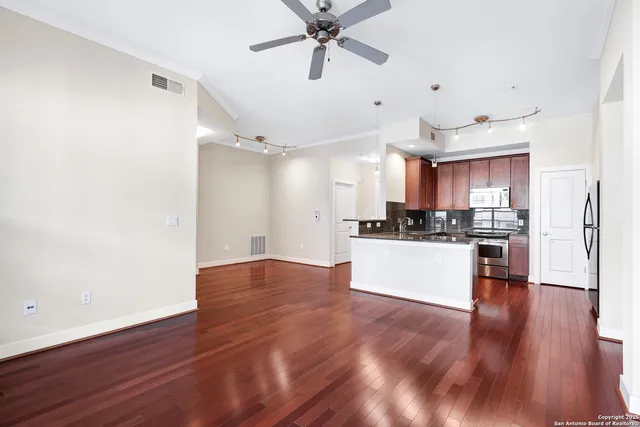 a view of kitchen with refrigerator microwave and stove
