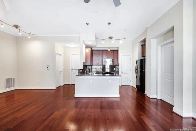 a view of a kitchen with wooden floor