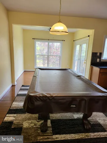 a view of a living room with furniture and a chandelier