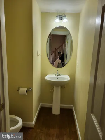 a bathroom with a sink toilet and a mirror