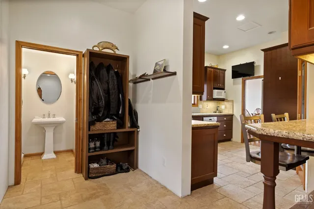 a bathroom with a sink mirror and toilet