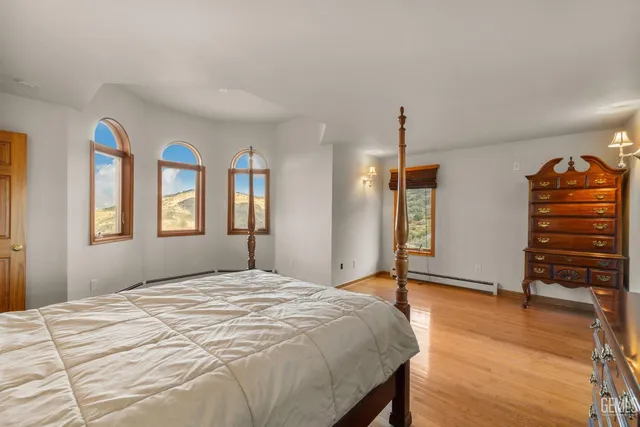 a bedroom with a large bed and a chandelier