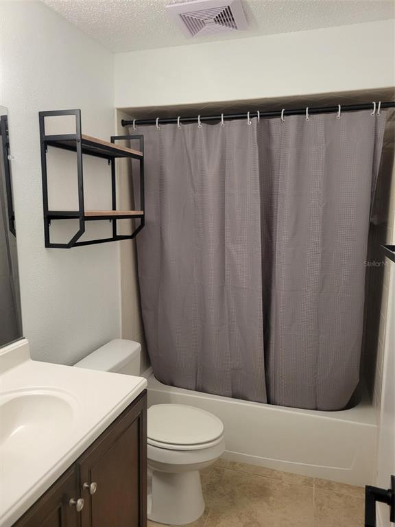 1112 5th Street Port Orange, FL 32129 - Photo 11 of 21 a white toilet sitting next to a bathroom sink