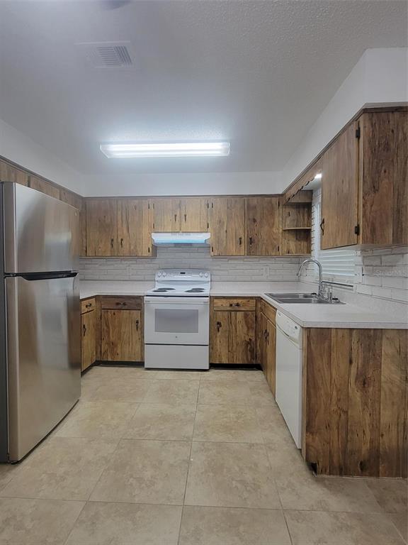 1112 5th Street Port Orange, FL 32129 - Photo 15 of 21 a kitchen with stainless steel appliances granite countertop a sink counter space cabinets and a large window