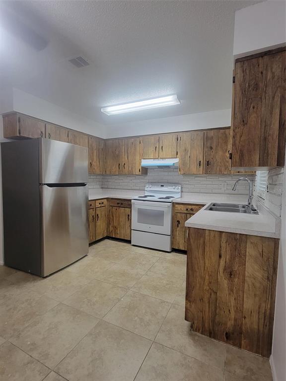 1112 5th Street Port Orange, FL 32129 - Photo 16 of 21 a kitchen with a sink stainless steel appliances and cabinets