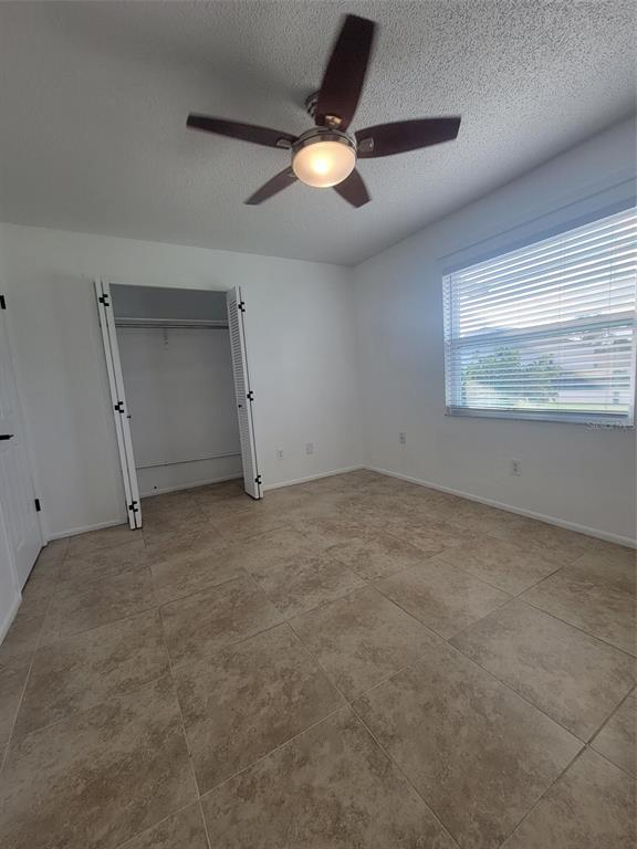 1112 5th Street Port Orange, FL 32129 - Photo 7 of 21 an empty room with a ceiling fan and window